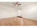 Empty living room with tile flooring and ceiling fan at 14413 N 91St St, Scottsdale, AZ 85260