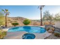 Inviting kidney-shaped pool with a spa and waterfall feature; mountain views at 14845 S 31St Way, Phoenix, AZ 85048