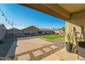 Charming backyard with paved patio, artificial turf, and string lights at 1537 E Caballero Dr, Casa Grande, AZ 85122