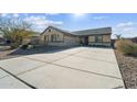 Single-story home with a two-car garage and landscaped front yard at 1537 E Caballero Dr, Casa Grande, AZ 85122