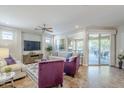 Bright and airy living room with access to the backyard patio at 1572 E Artemis Trl, Queen Creek, AZ 85140