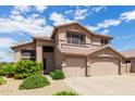 Two-story house with a three-car garage and desert landscaping at 18877 N 59Th Dr, Glendale, AZ 85308