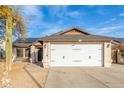 Street view of a single-story house boasting a two-car garage and solar panels at 21063 N 33Rd Ln, Phoenix, AZ 85027