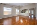 Spacious dining room with hardwood floors and large windows providing natural light at 2115 W Harwell Rd, Phoenix, AZ 85041