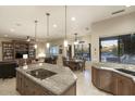 Spacious kitchen boasts granite countertops, modern appliances, and an island with a cooktop at 23861 N 74Th Pl, Scottsdale, AZ 85255