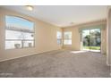 Spacious living room with carpeting and sliding glass doors at 23901 S Vacation Way, Sun Lakes, AZ 85248