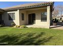 Covered patio with sliding glass door and lush green grass at 23901 S Vacation Way, Sun Lakes, AZ 85248