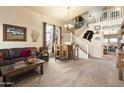 Spacious living room with southwestern decor, fireplace, and open staircase at 2509 W Straight Arrow Ln, Phoenix, AZ 85085