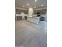 Modern kitchen with gray cabinets, island, and tile floors at 25312 W Bowker St, Buckeye, AZ 85326