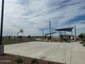 Community basketball court with shade structures and playground nearby at 25318 W Bowker St, Buckeye, AZ 85326