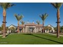 Community clubhouse with lush landscaping and palm trees at 26111 N 23Rd Ave, Phoenix, AZ 85085