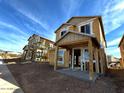 Two-story house under construction, featuring a covered porch and modern design at 26111 N 23Rd Ave, Phoenix, AZ 85085