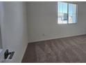 Neutral bedroom offers cozy carpet, natural light from the window, and a versatile space at 2657 E Abe Truckle Ave, San Tan Valley, AZ 85140