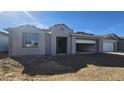 New construction home showing front elevation, gravel yard, and attached two-car garage at 2657 E Abe Truckle Ave, San Tan Valley, AZ 85140