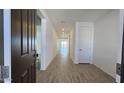 Inviting hallway features wood-look tile flooring, neutral walls, and recessed lighting throughout at 2657 E Abe Truckle Ave, San Tan Valley, AZ 85140