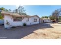 White ranch home with mature landscaping and a garage at 2905 W Stella Ln, Phoenix, AZ 85017