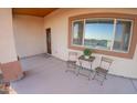 Small front porch with table and chairs at 34214 W Sahuaro St, Tonopah, AZ 85354