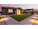 Artificial turf, covered patio, and exterior lighting in backyard at 35350 W Marin Ave, Maricopa, AZ 85138