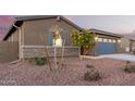 Side view of a house showcasing stone accents and landscaping at 35350 W Marin Ave, Maricopa, AZ 85138