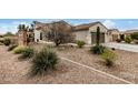 House exterior showcasing landscaping and a two-car garage at 3677 N Hudson Dr, Florence, AZ 85132