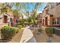 Pathway meanders through a residential community with desert landscaping and homes at 3935 E Rough Rider Rd # 1235, Phoenix, AZ 85050