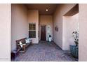 Covered entryway with tile flooring and a wooden bench at 41019 N Congressional Dr, Anthem, AZ 85086