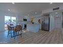 Open concept kitchen and dining area with modern appliances and stylish furniture at 5725 W Osborn Rd, Phoenix, AZ 85031