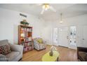 Bright living room with wood floors and comfy seating at 6611 N 181St Ave, Waddell, AZ 85355