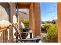 Covered porch with two chairs, offering a relaxing outdoor space at 8088 W Cinder Brook Way, Florence, AZ 85132