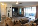 Living room with couches, large TV, and sliding doors leading to a lanai at 8600 E Broadway Rd # 43, Mesa, AZ 85208