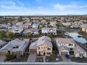 Aerial view of a residential neighborhood with houses and a pond at 904 E Hampton Ln, Gilbert, AZ 85295