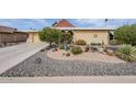 Charming front yard featuring desert landscaping and a well-maintained lawn at 10814 W Palmeras Dr, Sun City, AZ 85373