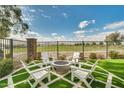 Backyard with firepit and seating area, overlooking a golf course at 11746 N San Clemente St, Surprise, AZ 85388