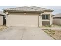 One-story home with attached garage and desert landscaping at 13558 W Saguaro Ln, Surprise, AZ 85374