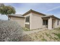 Tan house exterior with a covered entryway at 13558 W Saguaro Ln, Surprise, AZ 85374