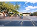 Charming mid-century modern home with mature landscaping and a spacious driveway at 13801 N 57Th St, Scottsdale, AZ 85254