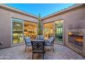 Private courtyard with seating area and fireplace, adjacent to kitchen at 1401 E Sweet Citrus Dr, Queen Creek, AZ 85140