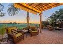 Relaxing patio with fire pit and seating area, overlooking golf course at 1401 E Sweet Citrus Dr, Queen Creek, AZ 85140