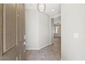 Bright entryway with tile flooring and a modern light fixture at 1719 W Owens Way, Anthem, AZ 85086