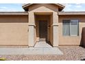 House entrance with a brown door and stone accents at 1719 W Owens Way, Anthem, AZ 85086