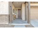 Covered front porch entry with wood beams and a decorative console table at 22455 E Camina Buena Vis, Queen Creek, AZ 85142