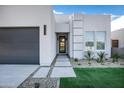 Contemporary home with gray garage door and walkway, plus drought-tolerant landscaping at 2330 N 28Th Pl, Phoenix, AZ 85008