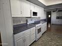White cabinets, blue countertop kitchen with appliances at 2650 W Union Hills Dr # 33, Phoenix, AZ 85027