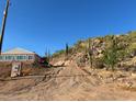 Driveway leading to a home nestled in a desert landscape at 2960 W Tonto St, Apache Junction, AZ 85120