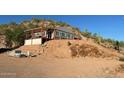 House on hillside with desert landscape and wooden pergola at 2960 W Tonto St, Apache Junction, AZ 85120