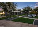 Contemporary home with curved architecture and a beautifully landscaped front yard at 3282 E Palo Verde Dr, Paradise Valley, AZ 85253