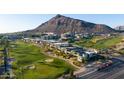 Aerial view of the community featuring modern homes, lush golf course, and mountain backdrop at 4849 N Camelback Ridge Dr # A101, Scottsdale, AZ 85251