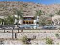 Community pool with poolhouse, mountain views, lounge chairs and privacy fence at 4849 N Camelback Ridge Dr # A101, Scottsdale, AZ 85251