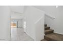 Modern staircase with carpeted steps and tile flooring at 5111 E Umber Rd, San Tan Valley, AZ 85143