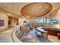 Spacious living room with a stone fireplace, leather sofas, and a built-in bar at 6520 E El Sendero Rd, Carefree, AZ 85377